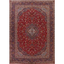 A WOOL HAND KNOTTED FLORAL MEDALLION AREA RUG.