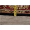 Image 11 : A WOOL HAND KNOTTED FLORAL AREA RUG.