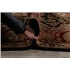 Image 12 : A WOOL HAND KNOTTED FLORAL AREA RUG.