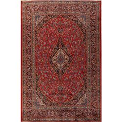 A WOOL HAND KNOTTED FLORAL ORIENTAL AREA RUG.