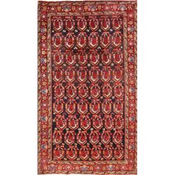 A WOOL HAND KNOTTED ORIENTAL AREA RUG.