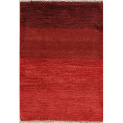 A WOOL HAND KNOTTED GABBEH AREA RUG.