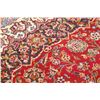 Image 11 : A WOOL HAND KNOTTED FLORAL AREA RUG.