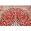 Image 12 : A WOOL HAND KNOTTED FLORAL AREA RUG.