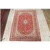 Image 2 : A WOOL HAND KNOTTED FLORAL AREA RUG.