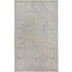 A WOOL HAND KNOTTED FLORAL OUSHAK ORIENTAL RUG.