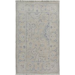 A WOOL HAND KNOTTED FLORAL OUSHAK RUG.