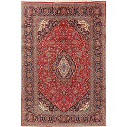 A WOOL HAND KNOTTED FLORAL MEDALLION AREA RUG.