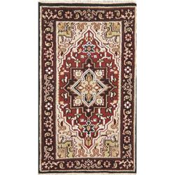 A WOOL HAND KNOTTED MEDALLION AREA RUG.
