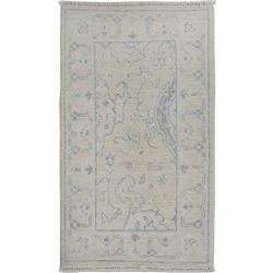 A WOOL HAND KNOTTED OUSHAK ORIENTAL AREA RUG.