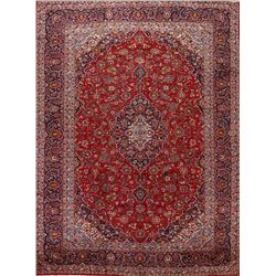 A WOOL HAND KNOTTED FLORAL MEDALLION AREA RUG.