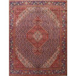 A WOOL HAND KNOTTED ORIENTAL AREA RUG.