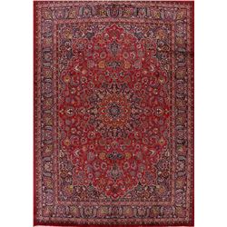 A WOOL HAND KNOTTED FLORAL MEDALLION AREA RUG.