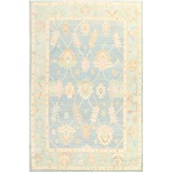 A WOOL HAND KNOTTED FLORAL TURKISH AREA RUG.