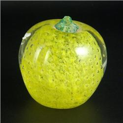 PAPERWEIGHT: Apple-shaped unsigned paperweight with a clear exterior. The interior is filled with fo