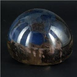 PAPERWEIGHT: Smoke-colored unsigned paperweight with a sea of small bubbles contain a small white ma