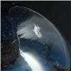 Image 2 : PAPERWEIGHT: Smoke-colored unsigned paperweight with a sea of small bubbles contain a small white ma