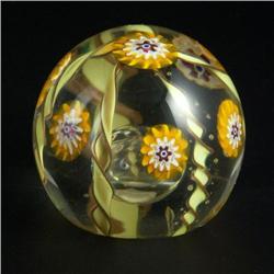 PAPERWEIGHT: Clear, having a series of “flowers” in a millefiori-like manner. In the center at the b