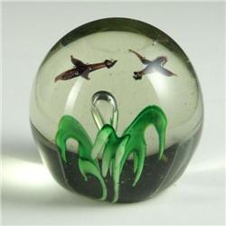 PAPERWEIGHT: Clear unsigned paperweight having a small single center “floral” piece with a single ri