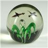Image 1 : PAPERWEIGHT: Clear unsigned paperweight having a small single center “floral” piece with a single ri