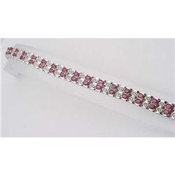 Ruby and diamond bracelet; 40 oval bloo