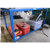 Image 1 : 2 red gasoline cans, 1 bucket of --- and a blue table with wheels