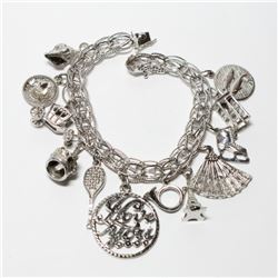 Vintage Sterling Silver Charm Bracelet with 12 Assorted Charms. Weight of 41.89 grams.