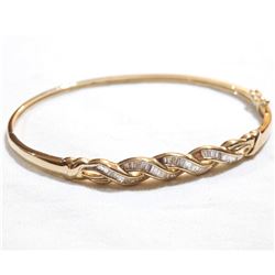 Lady's 10K Yellow Gold Baguette Diamond Inlayed Hinged Cuff Bracelet. Total weight of 8.4 grams.