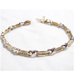 Lady's 14K Yellow & White Gold Channel Set Diamond Bracelet. Measures 7" in length with safety catch