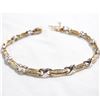 Image 1 : Lady's 14K Yellow & White Gold Channel Set Diamond Bracelet. Measures 7" in length with safety catch