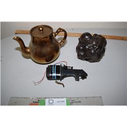 Strange Statue, Toy Boat Motor and Teapot