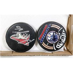 2 SIGNED HOCKEY PUCKS / NOT SURE OF PLAYER