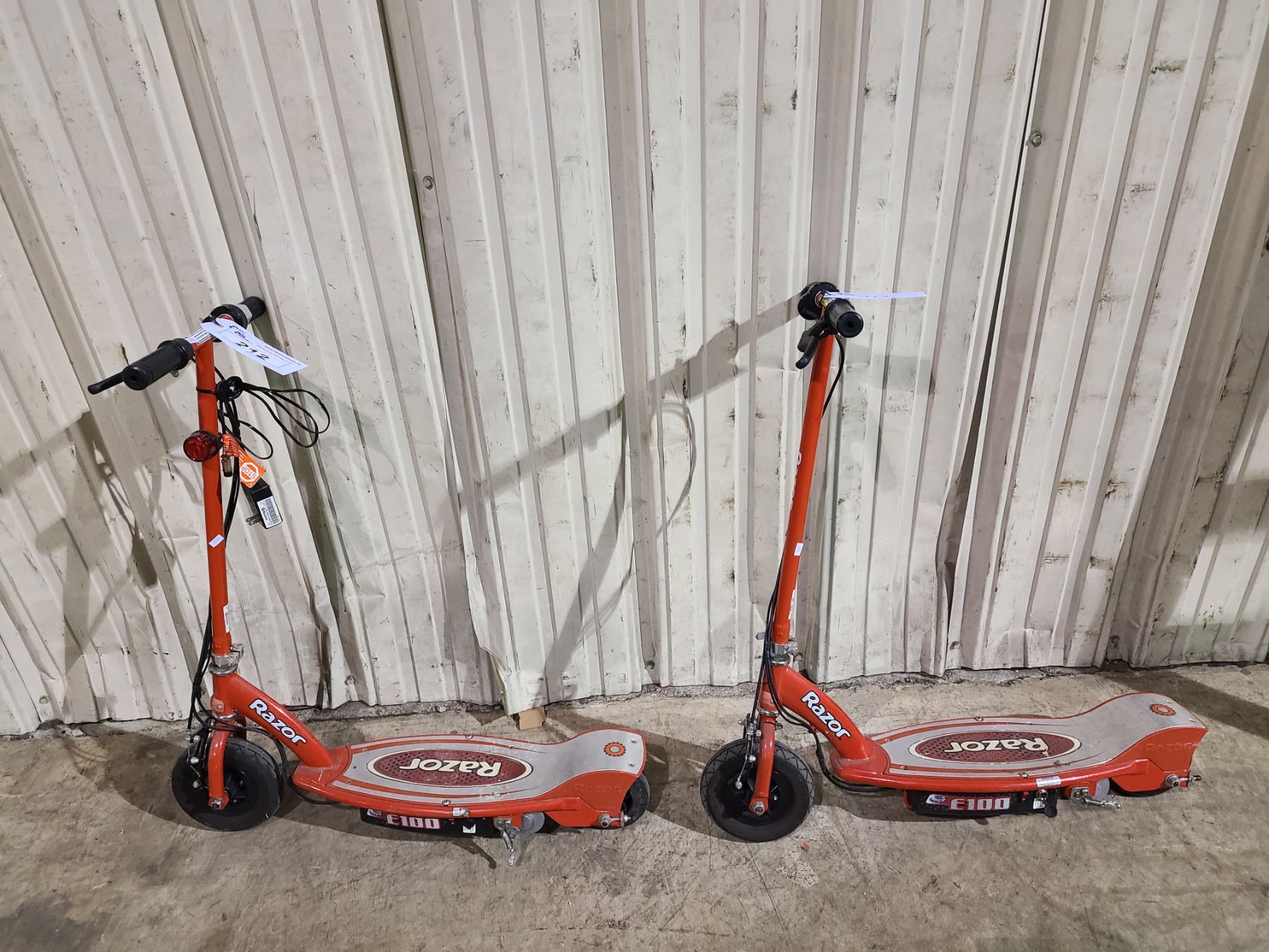2 RED RAZOR ELECTRIC SCOOTERS AND 1 CHARGER - Able Auctions