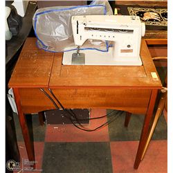 SINGER SEWING MACHINE IN A CABINET. 28"X18"X30"
