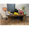Image 1 : DESK WITH ASSORTED OFFICE CONTENTS INCLUDING WASTE CANS, PAPER, CLOCKS, REFLECTIVE VESTS, CLEANING