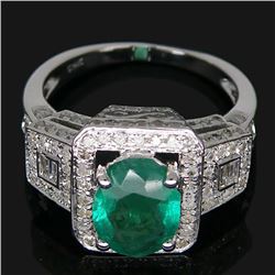 A 14KT WHITE GOLD AND EMERALD & DIAMONDS RING.