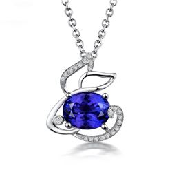 A 18KT WHITE GOLD AND TANZANITE & DIAMOND PENDANT.