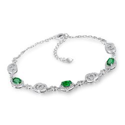 A 18KT WHITE GOLD AND EMERALD & DIAMOND BRACELET.