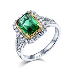 A 18KT WHITE GOLD AND EMERALD & DIAMONDS RING.