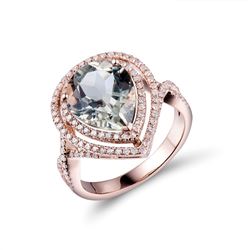 A 14KT ROSE GOLD AND AMETHYST & DIAMONDS RING.