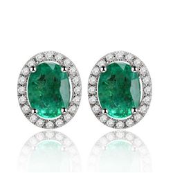 A 14KT WHITE GOLD AND EMERALD & DIAMONDS EARRINGS.