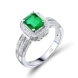 A 14KT WHITE GOLD AND EMERALD & DIAMONDS RING.