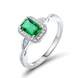 A 18KT WHITE GOLD AND EMERALD & DIAMONDS RING.