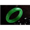 Image 1 : A NATURAL GREEN JADE BANGLE.