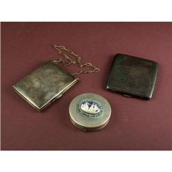 Three silver cigarette/vanity cases to include a German Silver case on a brass chain.  The interior 