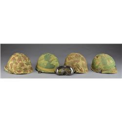 4 US M1 HELMETS W/ CAMOUFLAGE COVERS.