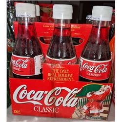 1 case of coke classic with styrofoam labels and 2 vintage long neck bottles and 5 clear bottles