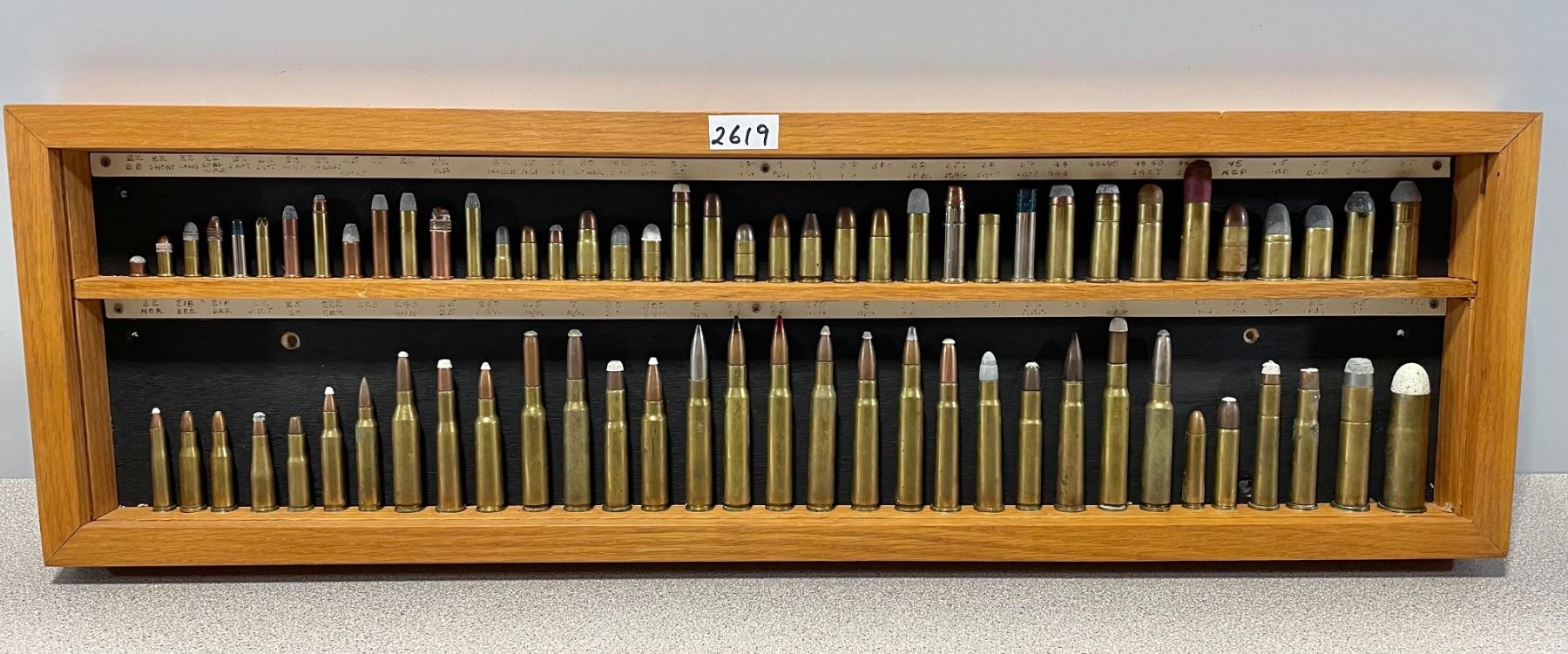 AMMO: COLLECTION OF 70+ CARTRIDGES IN WOOD DISPLAY - Kidd Family Auctions