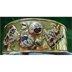 Cuff bracelet with gemstones in 18 kt gold. #1402718