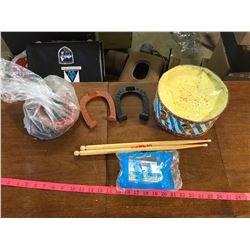 lot of toy horse shoes + drum that comes with drum sticks + etc.